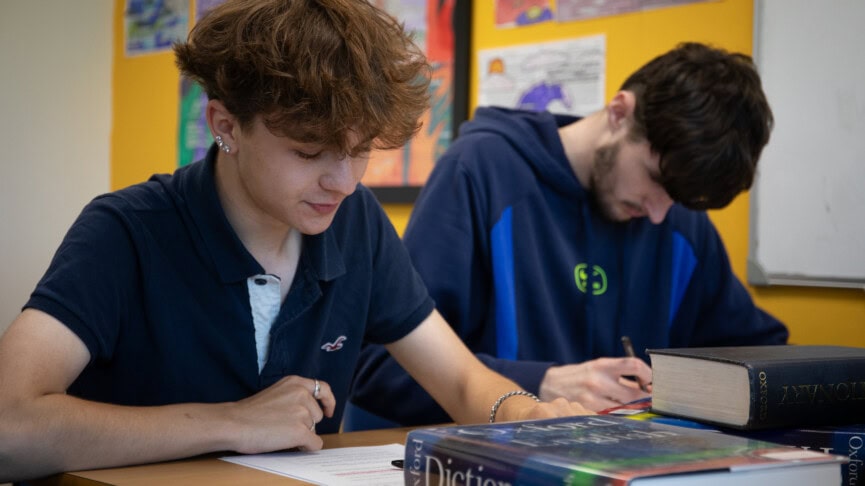 Two male students reading books