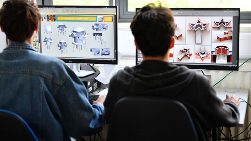 Two male students using CAD on desktop computers
