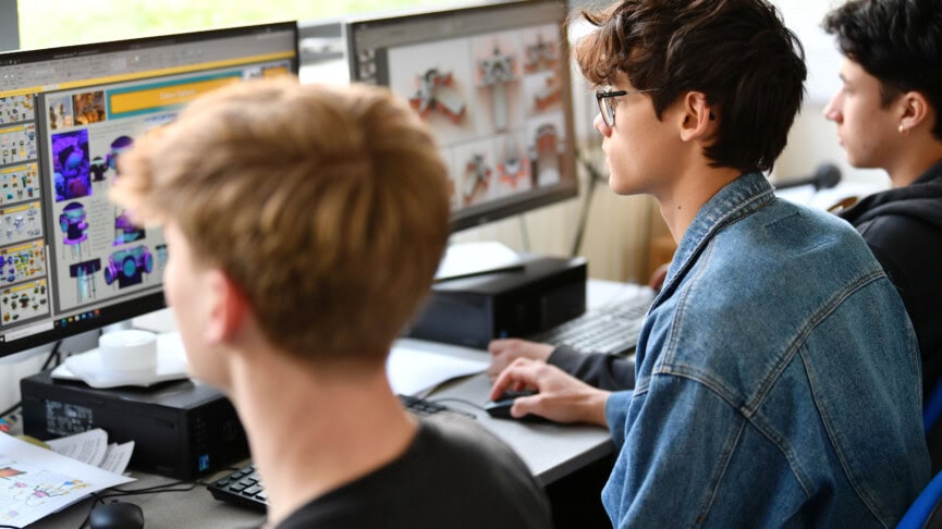 Male students using CAD on desktop computers