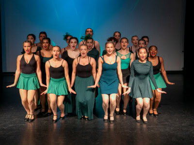 Group of students dancing and performing as part of a Wicked Ensemble