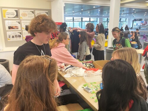 students gathering around a table at Clothes Swap