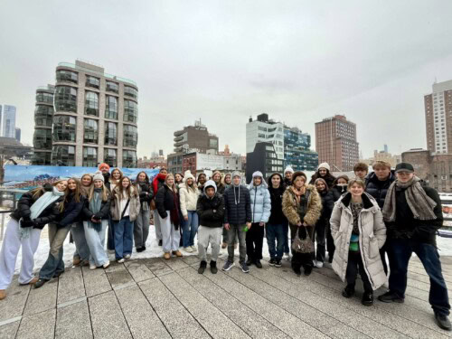 group shot standing on a rooftop in NY