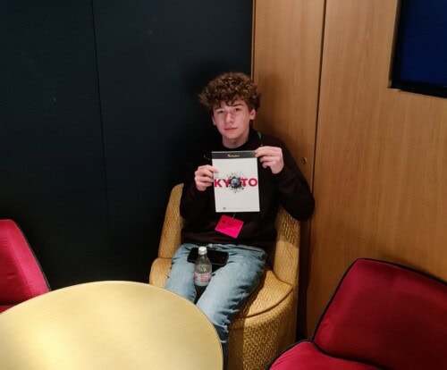 Male Student Sitting In Theatre Lobby