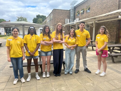 a row of student ambassadors standing the quad